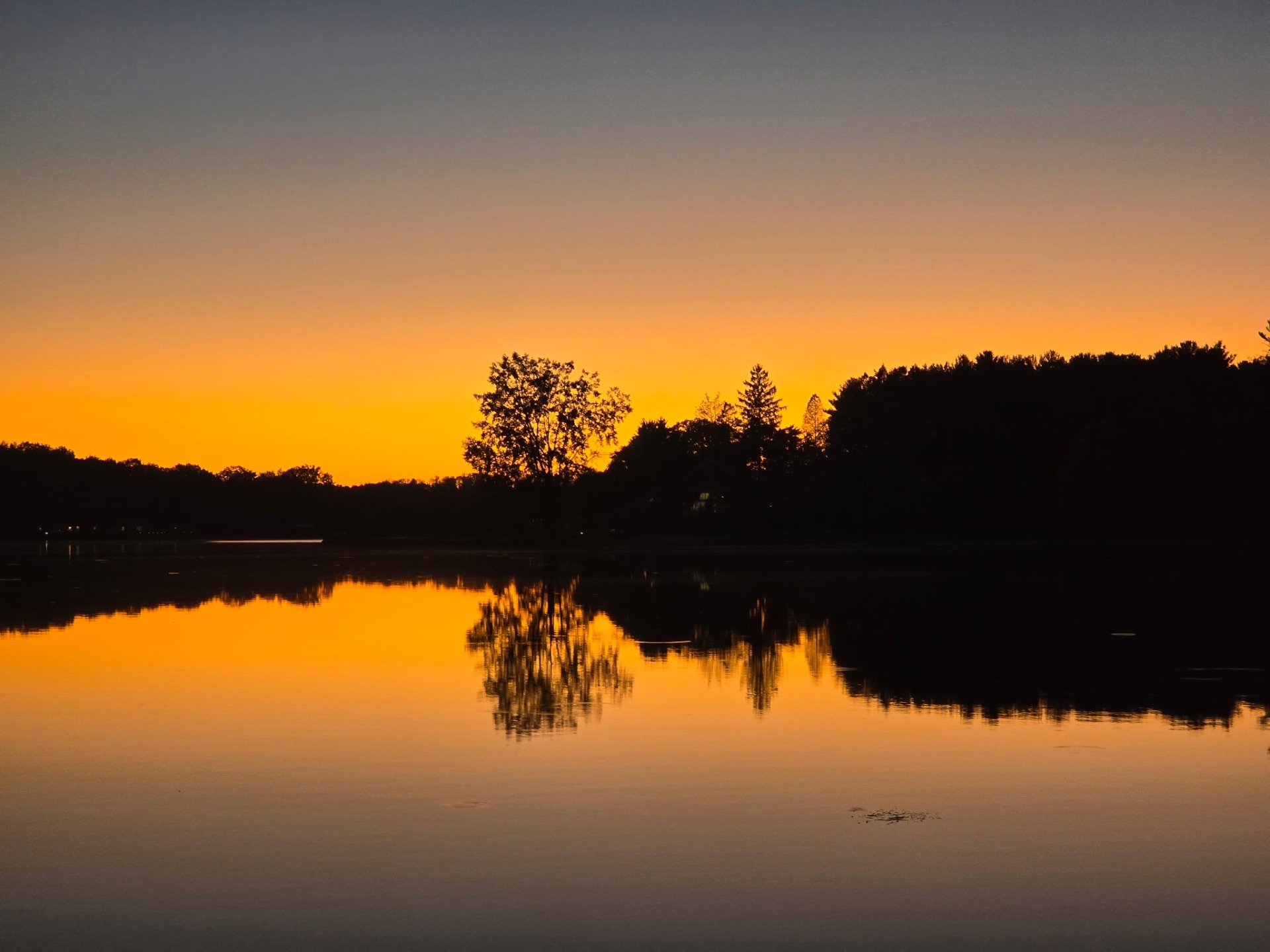 Orange sunset reflecting on still water