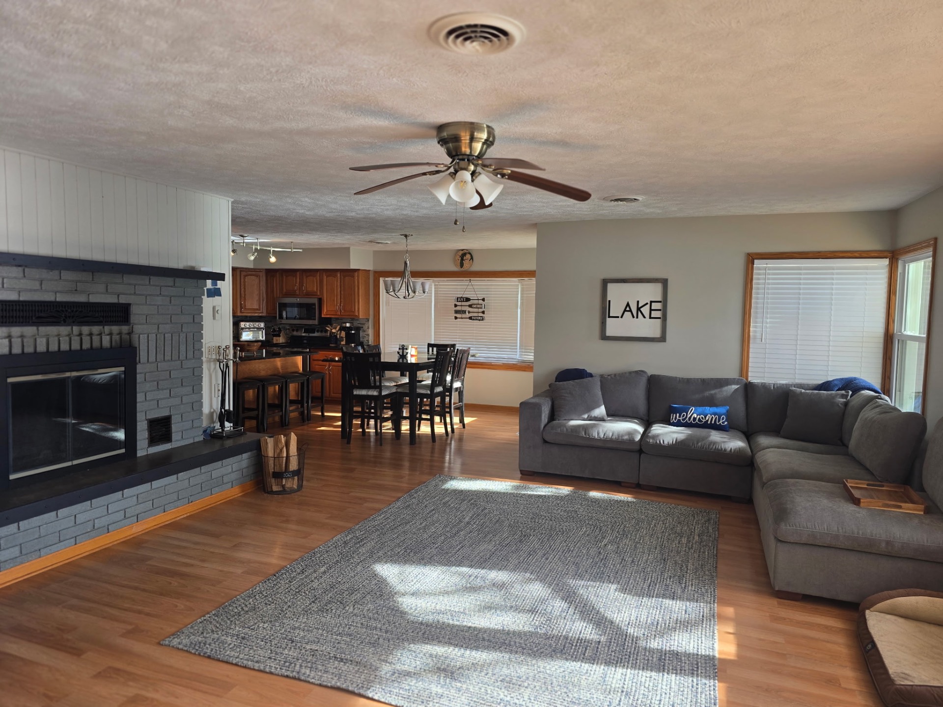 Open living, dining, and kitchen with fireplace